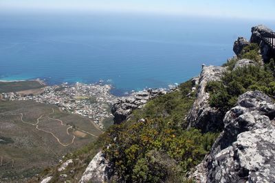 High angle view of sea and mountains against sky