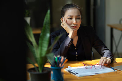 Tired businesswoman sitting at office