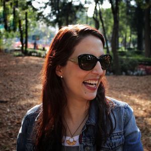 Close-up of happy young woman wearing sunglasses