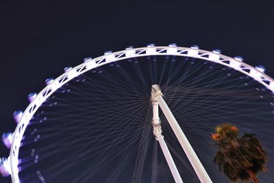 Low angle view of ferris wheel against sky at night