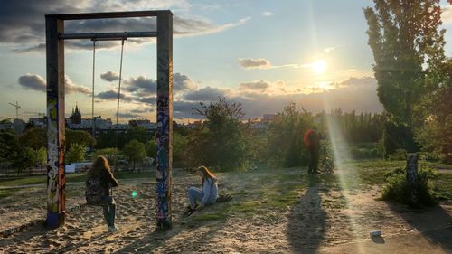 People at park against sky during sunset