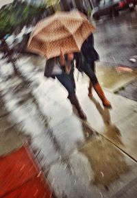 Blurred motion of people walking on road