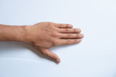 Close-up of hand against white background