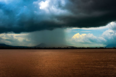 Scenic view of storm clouds over landscape