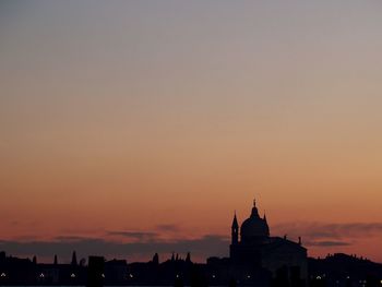 Silhouette built structures against clear sky