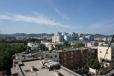 High angle view of buildings in city against sky