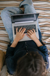 Directly above view of woman using laptop