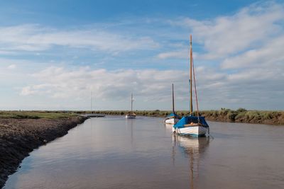 Boat moored on sea against sky