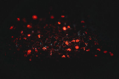 Close-up of illuminated fire against black background