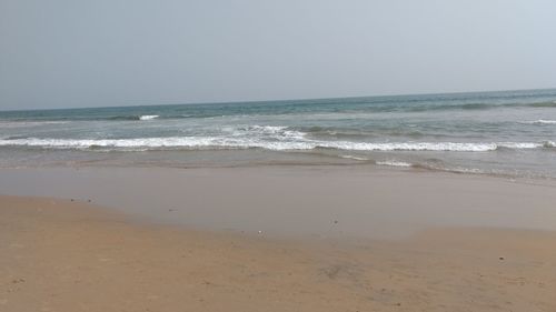 Scenic view of beach against clear sky