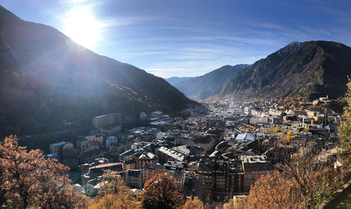 Aerial view of townscape and mountains against sky