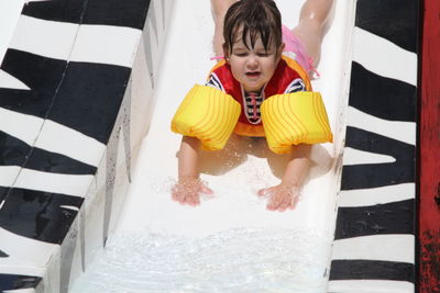 Cute girl enjoying on water slide