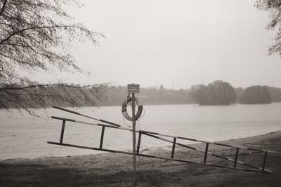 Built structure by trees against clear sky