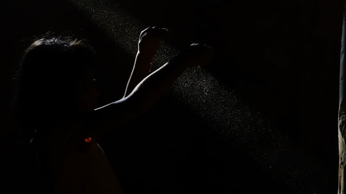 Rear view of woman at night