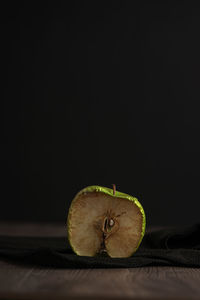 Close-up of fruit on table against black background