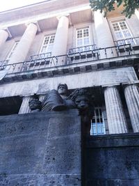 Low angle view of statue on building against sky