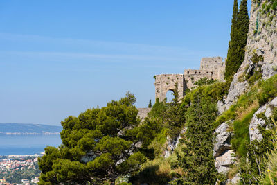 Medieval fortress on hill above city of split on coast of adriatic sea in croatia.