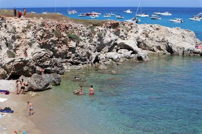 Group of people on rocks at beach