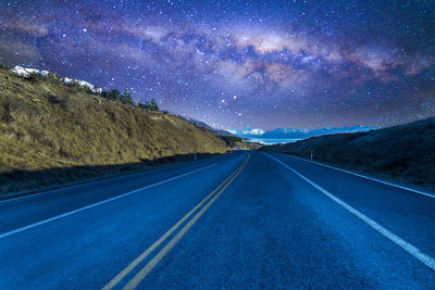 Road by street against sky at night
