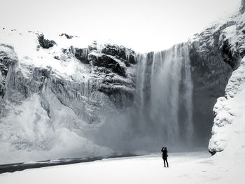 Scenic view of waterfall against sky