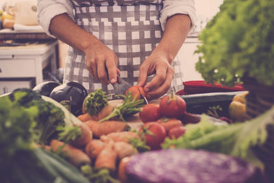 Midsection of man preparing food in kitchen