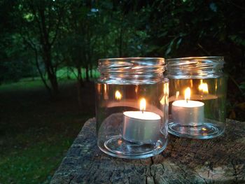 Close-up of lit tea light candle on table