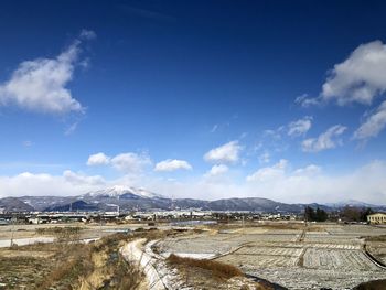 Scenic view of landscape against blue sky