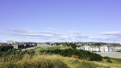 View of cityscape against blue sky