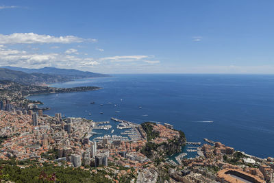 High angle view of buildings by sea against sky