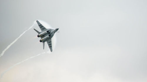 Low angle view of airplane flying in sky