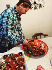 Young man looking away while standing on table