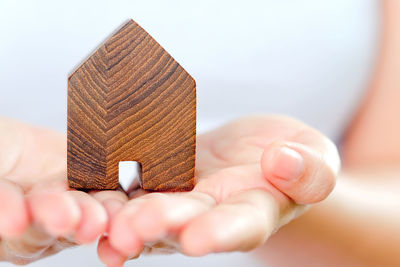 Midsection of woman holding wooden house block