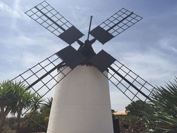 Low angle view of windmill against sky