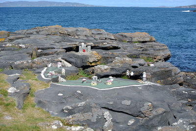 Model buildings forming a village built on rocky seashore