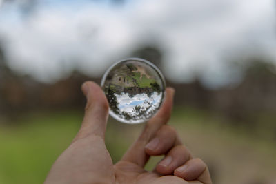 Cropped hand holding crystal ball