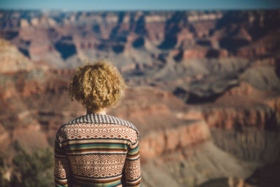 Rear view of woman looking at canyon