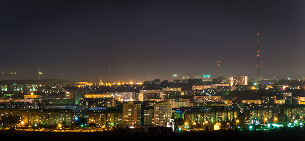 High angle view of illuminated buildings against sky at night