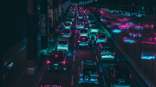 High angle view of illuminated cars in city at night