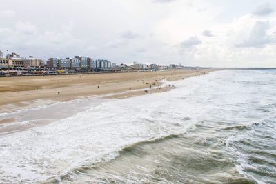 View of beach against cloudy sky