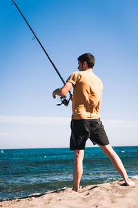 Full length of man on beach against sky