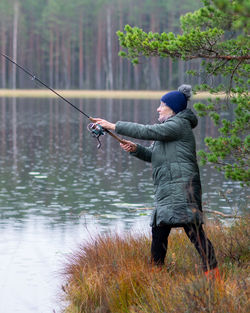 Rear view of man standing in lake