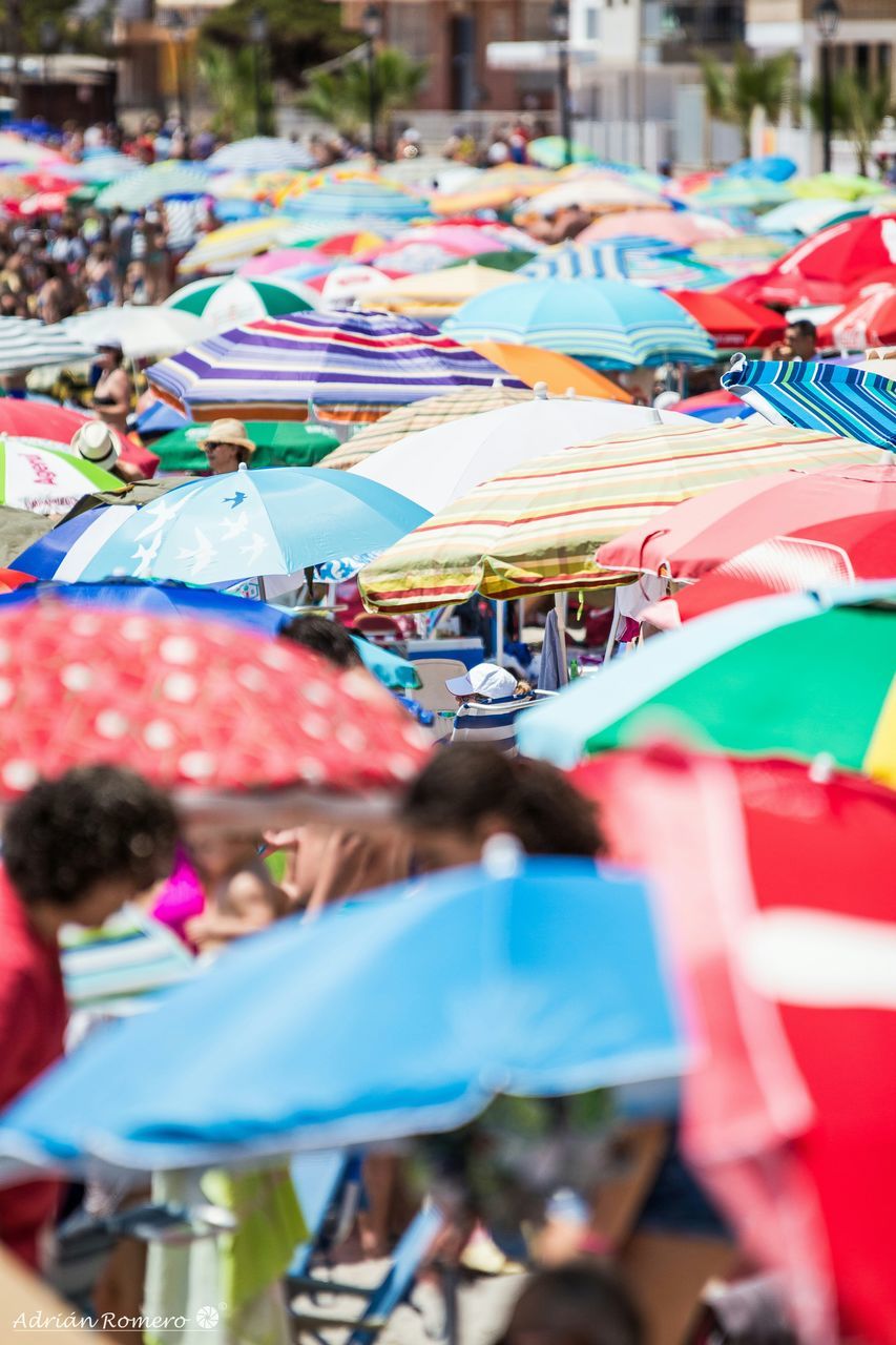 multi colored, focus on foreground, art and craft, tradition, selective focus, celebration, incidental people, cultures, arts culture and entertainment, art, umbrella, amusement park ride, creativity, large group of people, amusement park, day, flag, religion, decoration