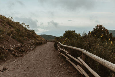 Road amidst trees against sky