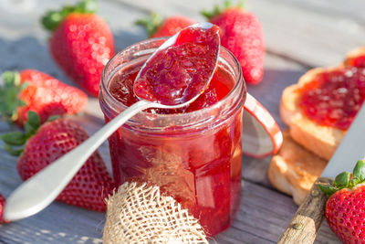 Close-up of strawberries in glass jar on table