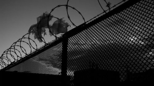 Low angle view of fence against clear sky