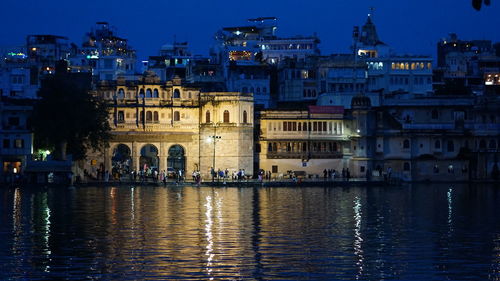 Reflection of illuminated buildings in city at night