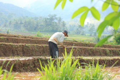 Side view of man standing on field