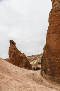 Low angle view of rock formations against sky