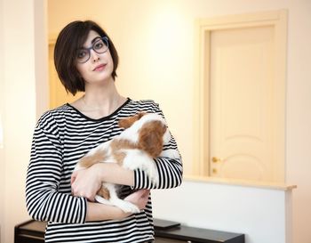 Portrait of woman with cat at home