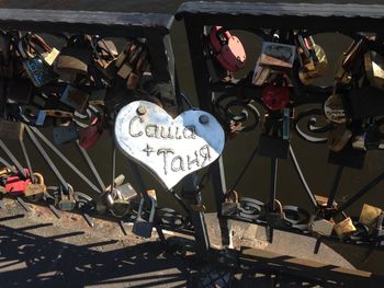 High angle view of padlocks on railing